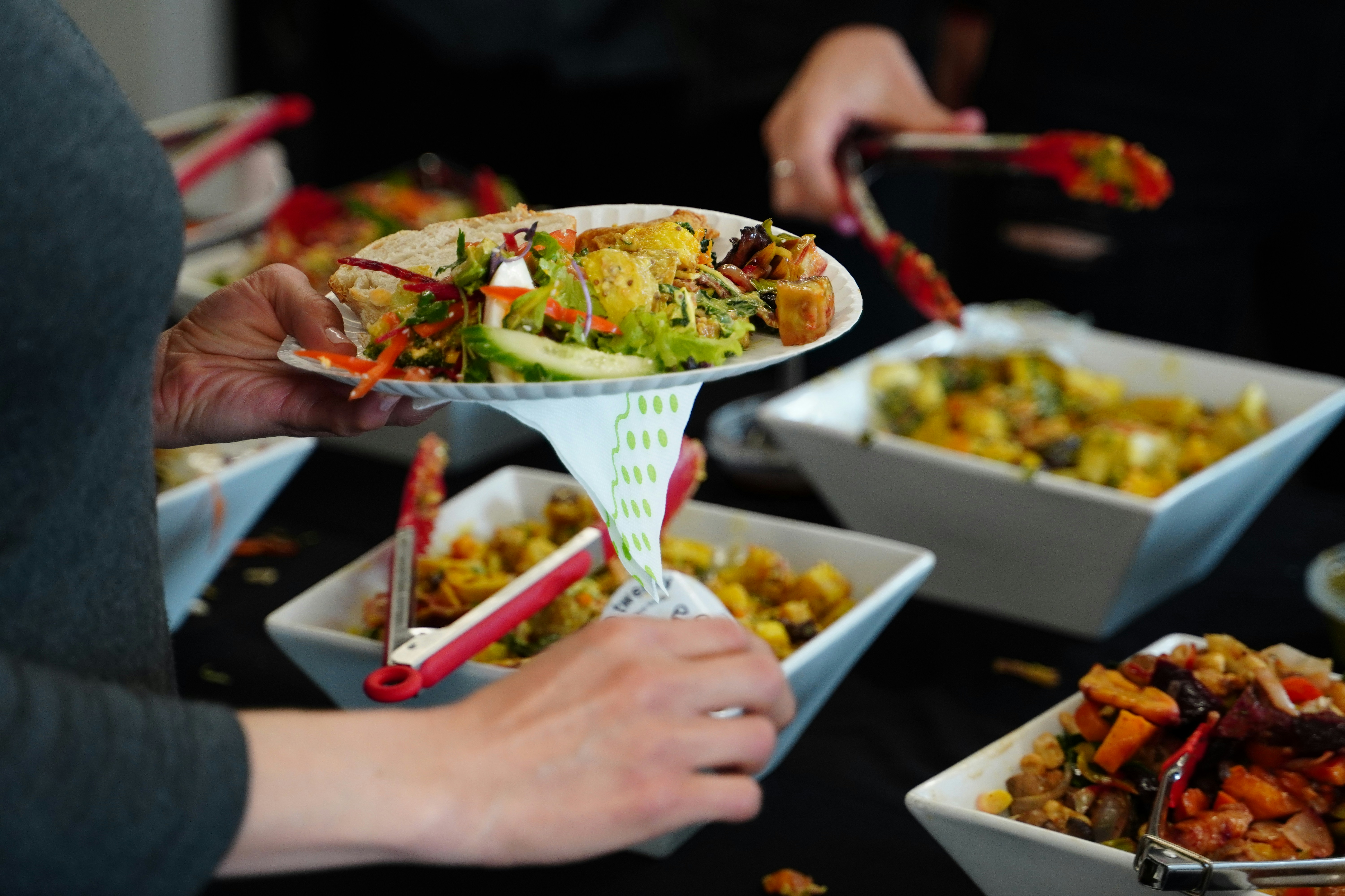 a group of people sitting at a table with a plate of food