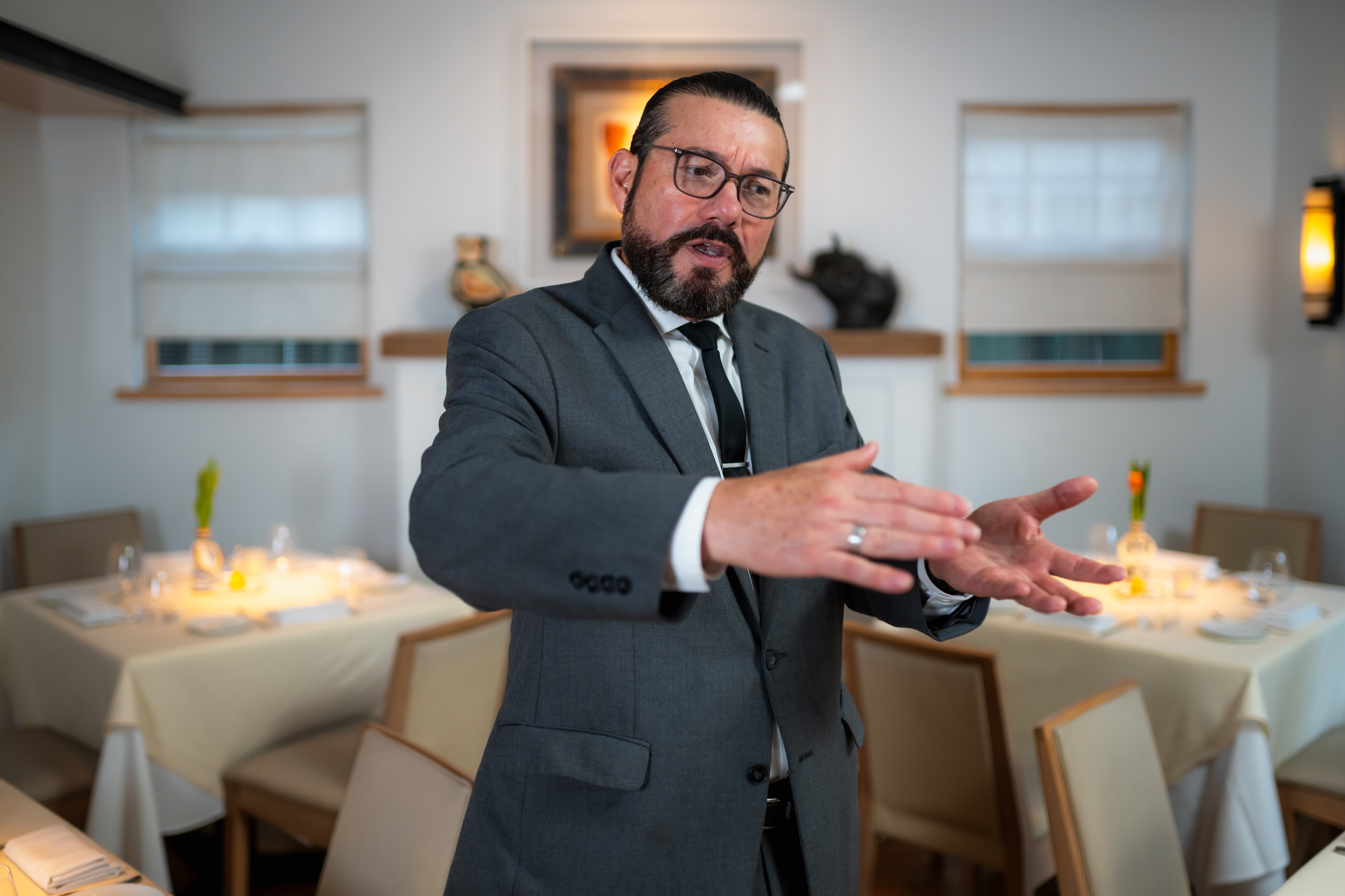 a man wearing a suit and tie eating food