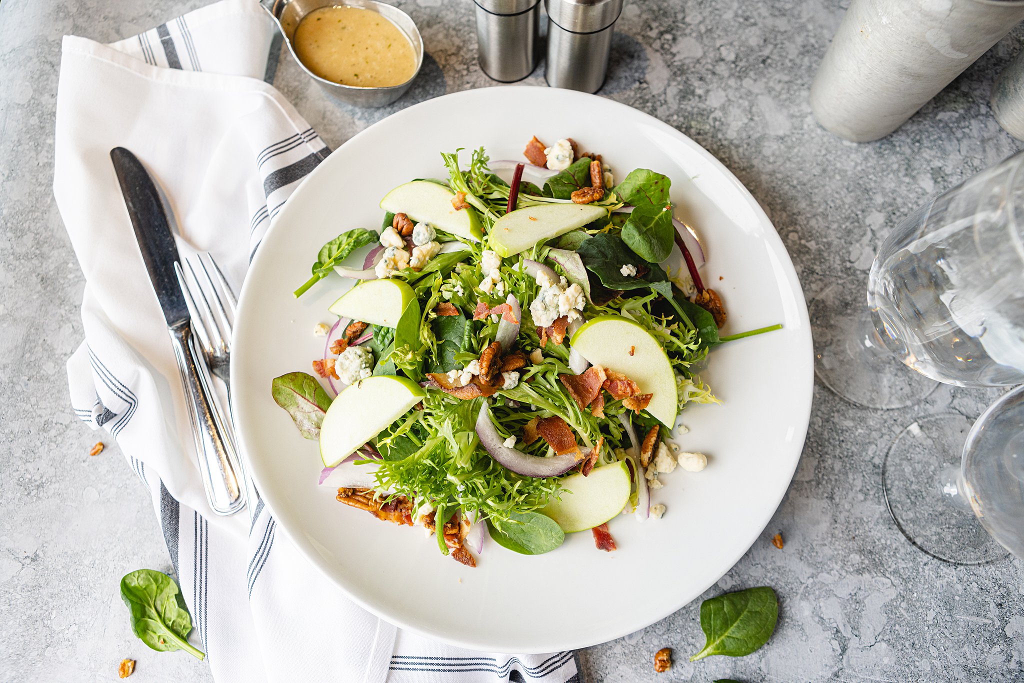a bowl of salad on a plate on a table