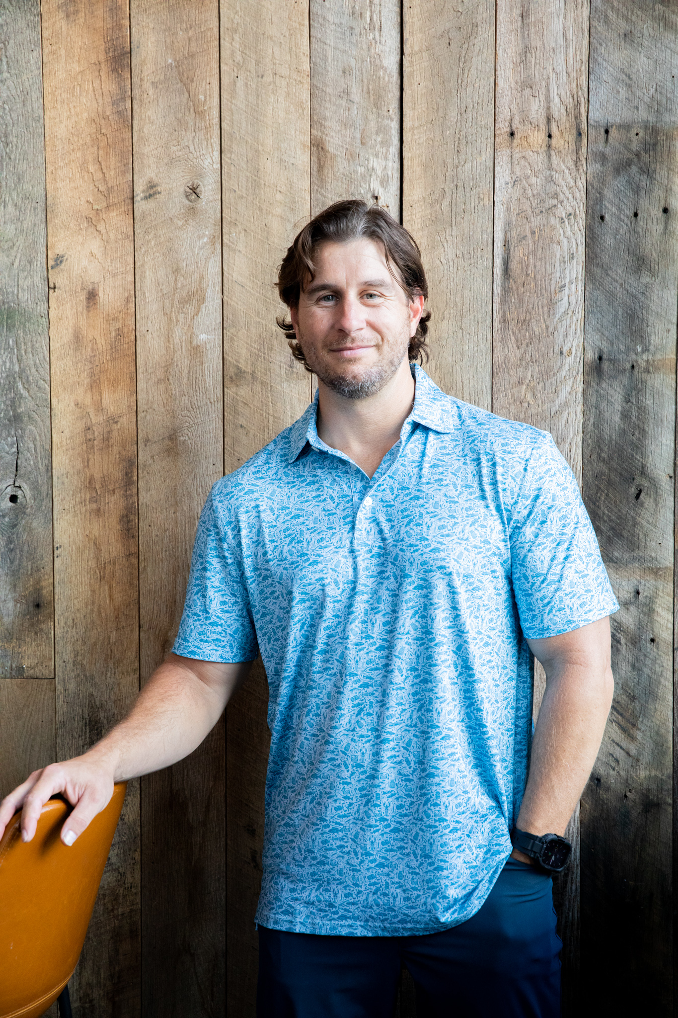 a man in a blue shirt standing in front of a building