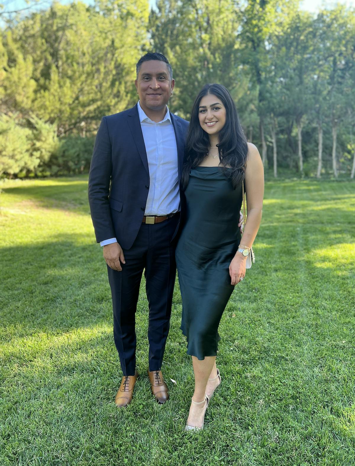 a man and a woman standing in a field