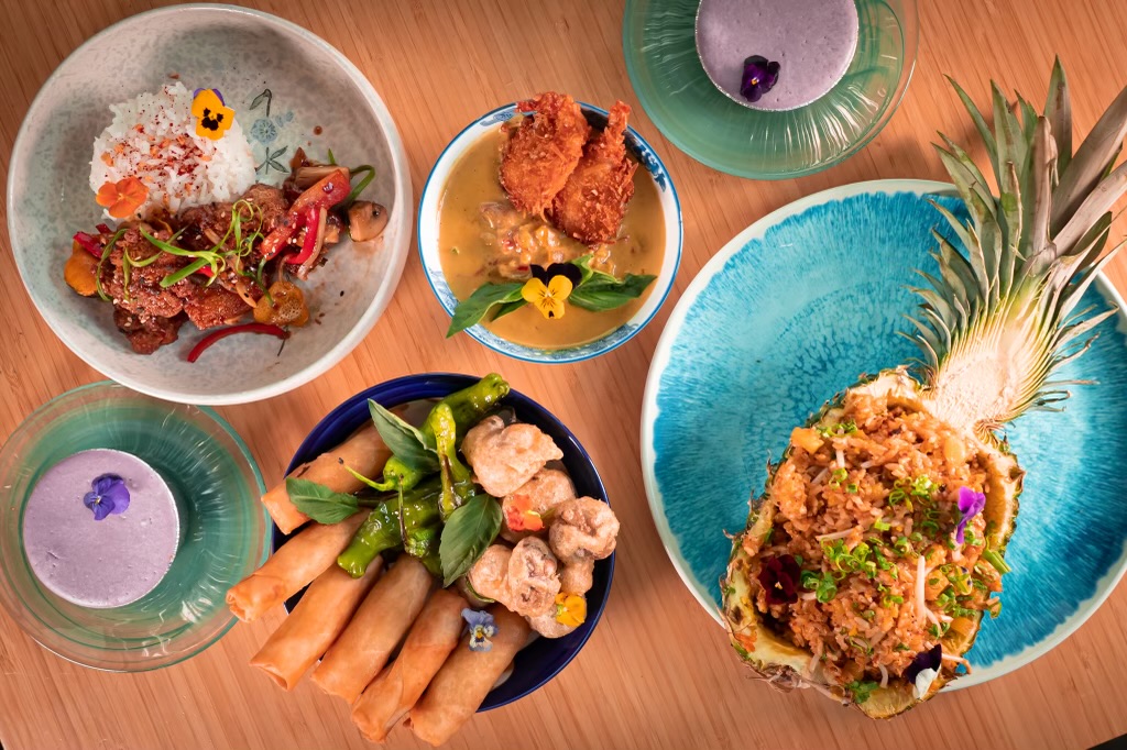 a bowl of food sitting on top of a wooden table
