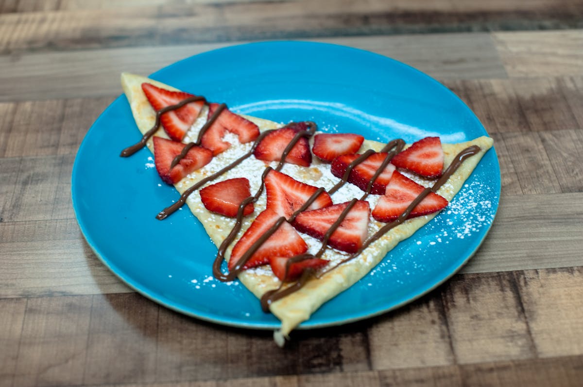 a blue and white plate sitting on top of a wooden cutting board