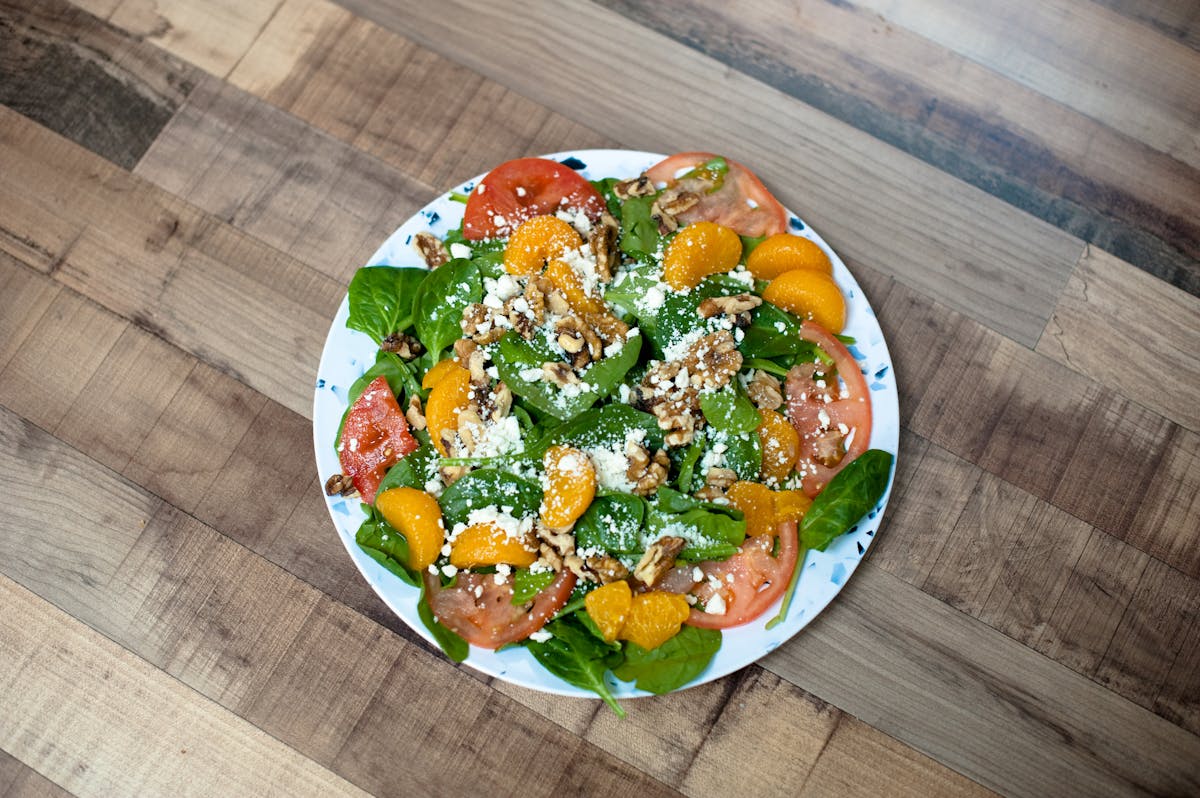 a plate of food sitting on top of a wooden table