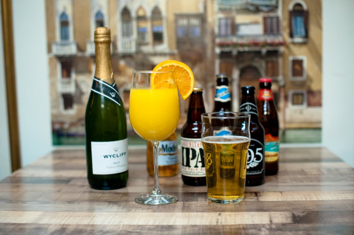 a bottle of wine and a glass of beer on a table