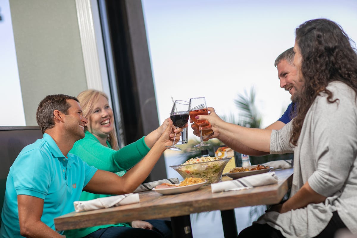 a group of people sitting at a table eating food
