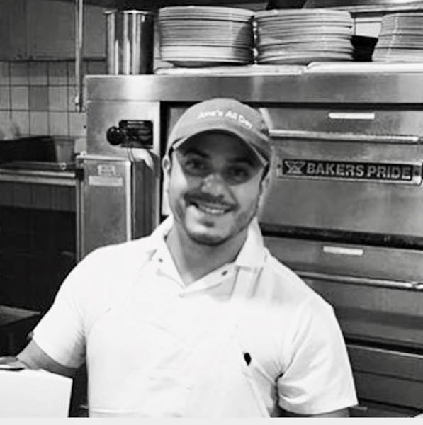 a man preparing food in a kitchen
