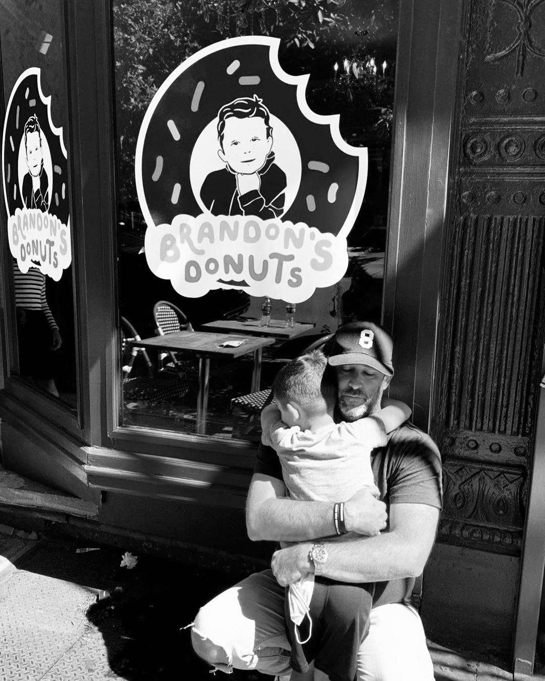 a man sitting on a bench in front of a store
