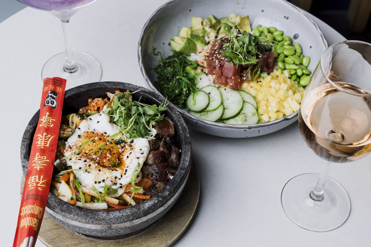 a plate of food and a glass of wine