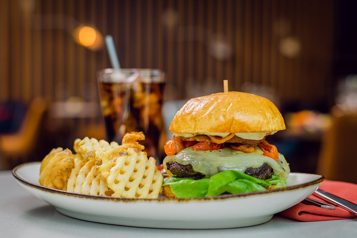 a sandwich sitting on top of a plate of food on a table