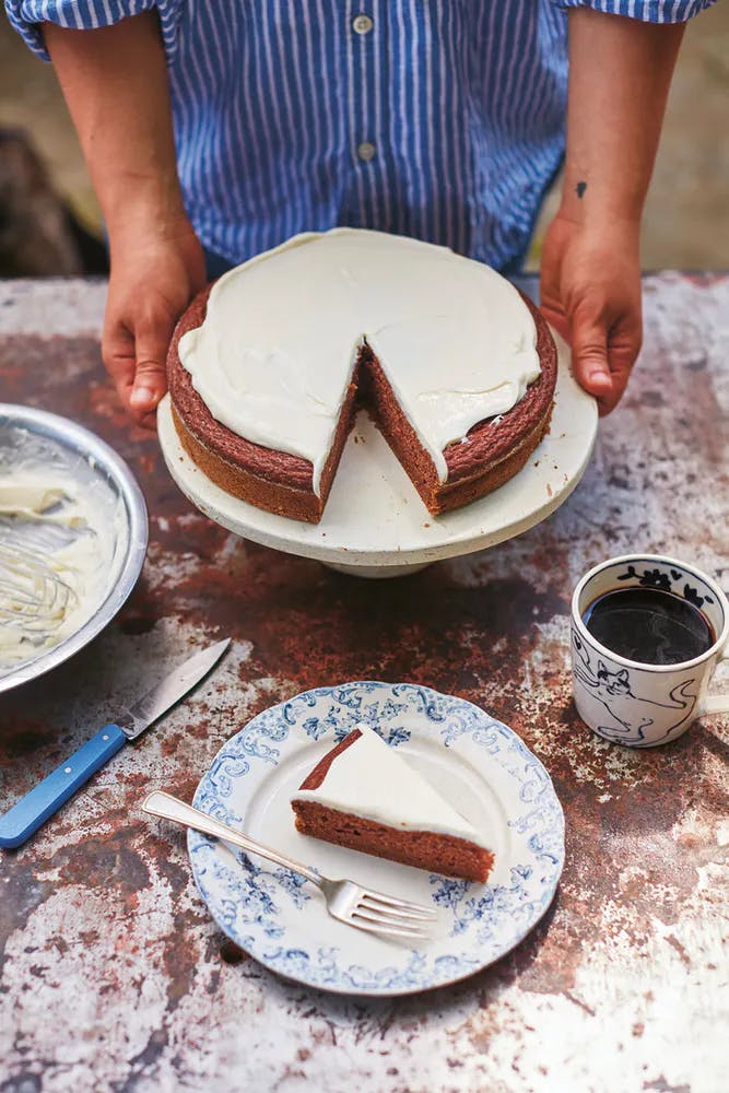 a person cutting a cake on a plate
