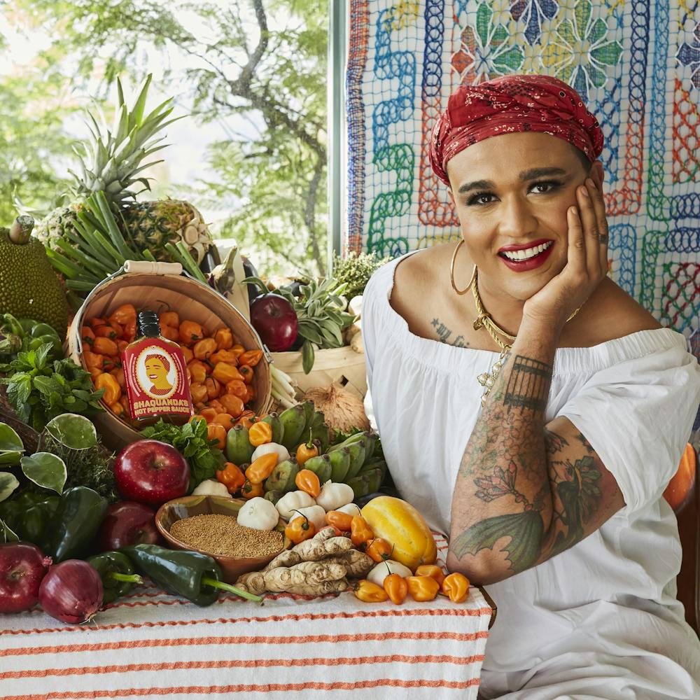 a person sitting at a fruit stand