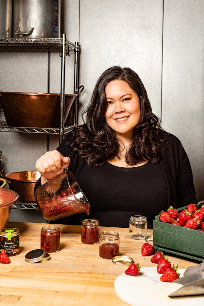 a woman sitting at a table with food