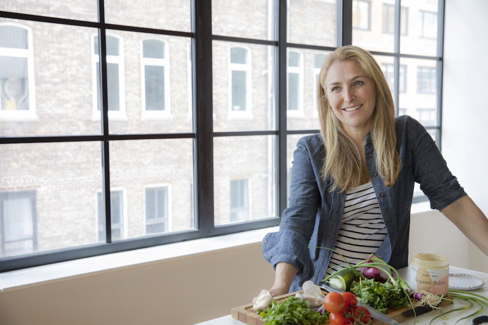 Rachel Kozlowski sitting at a table in front of a window