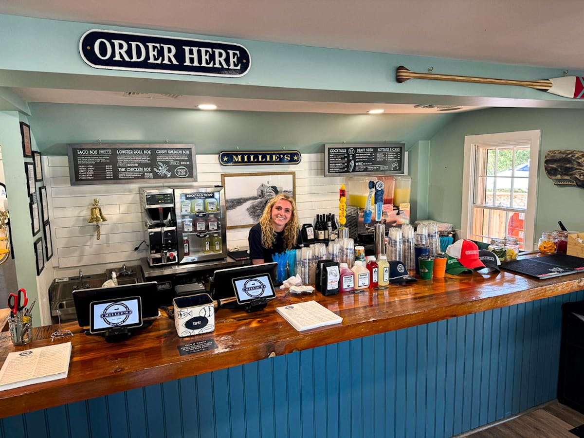 a counter with a stack of flyers on a table