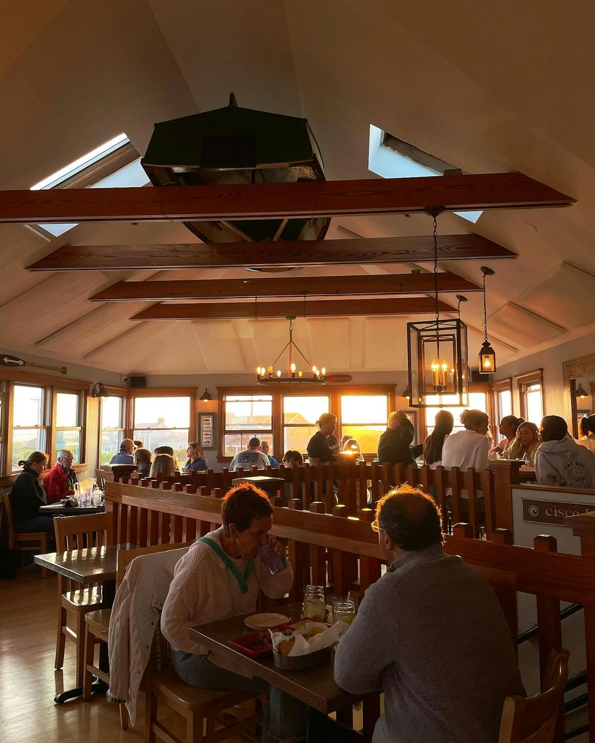 a group of people sitting at a table in a restaurant