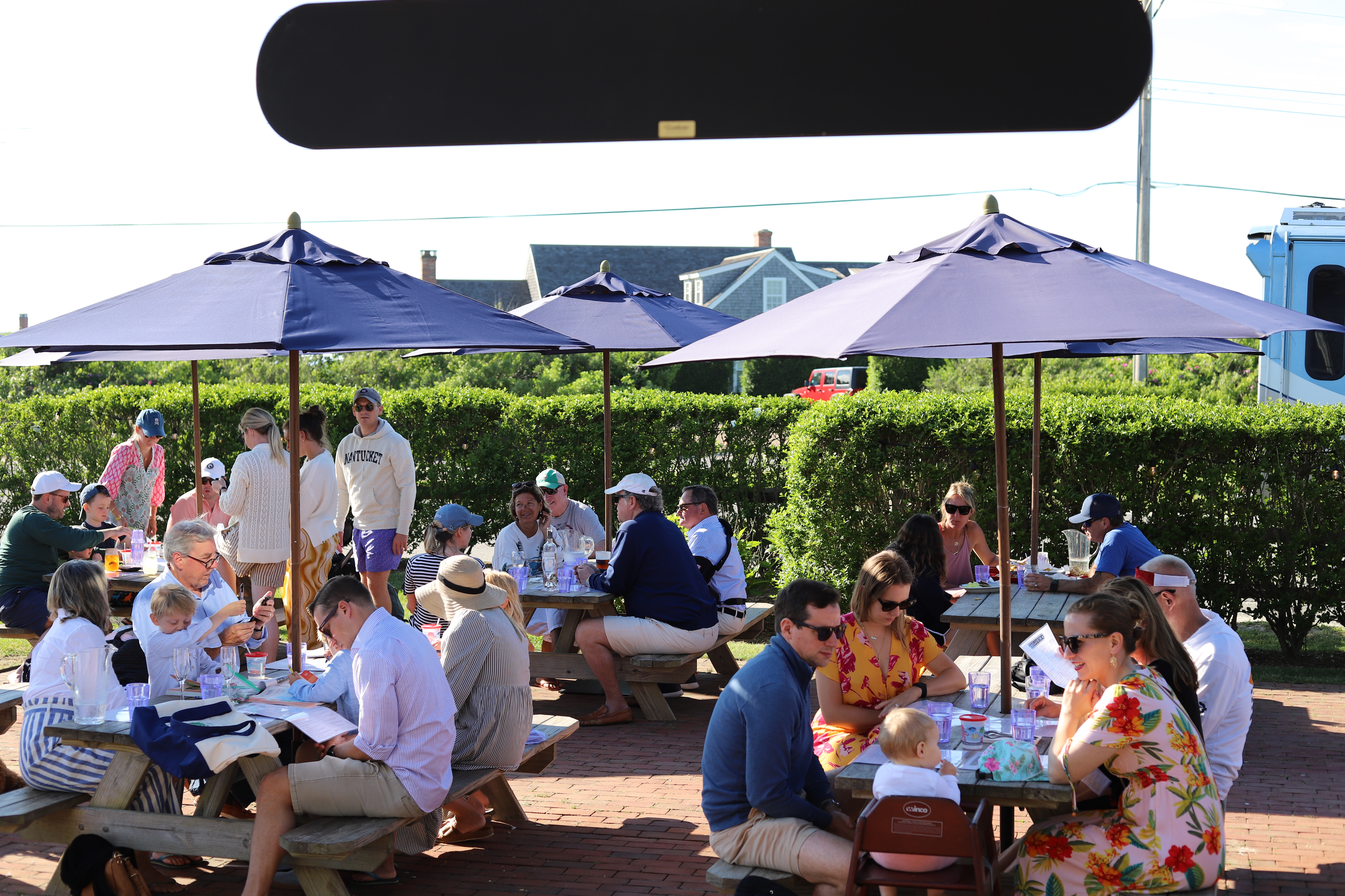 a group of people sitting at a table in front of a crowd