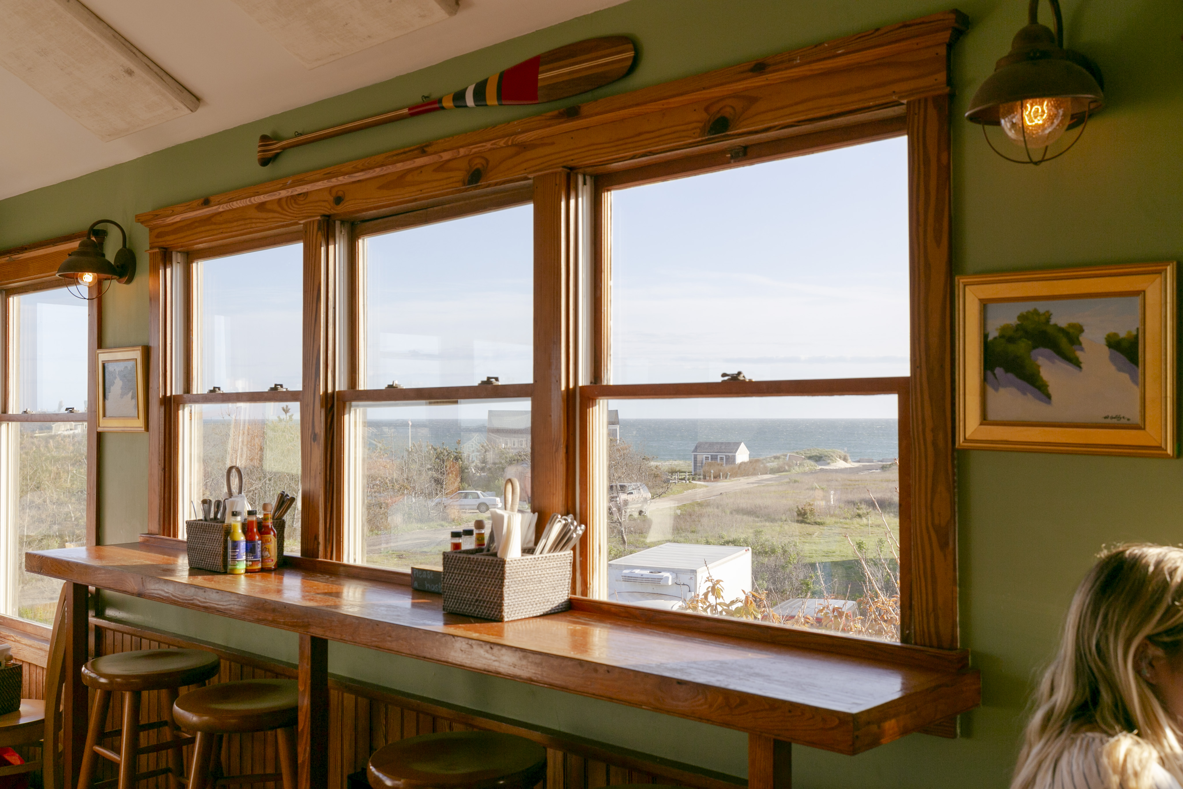 a person sitting at a table in front of a window