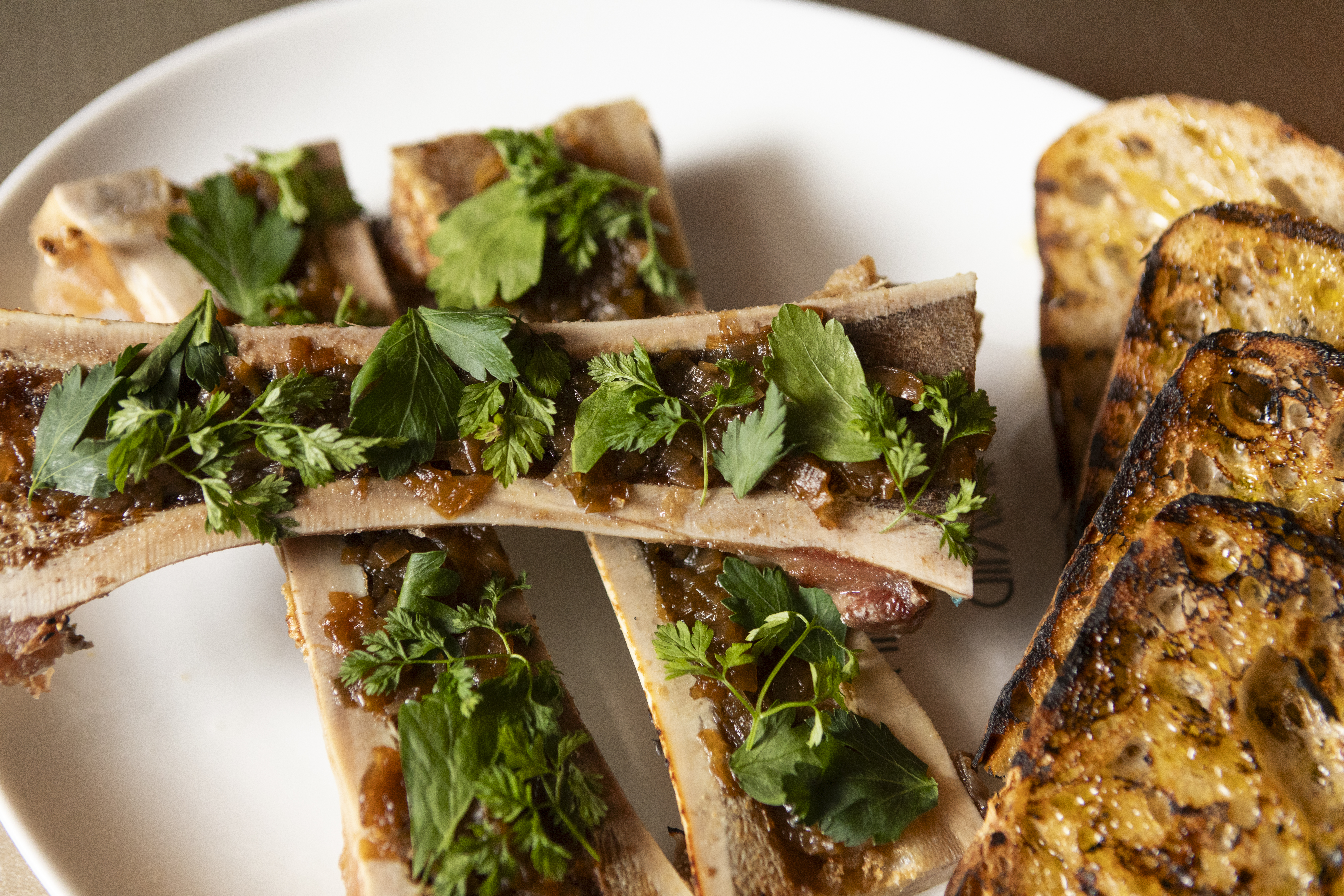 bone marrow entree garnished with herbs