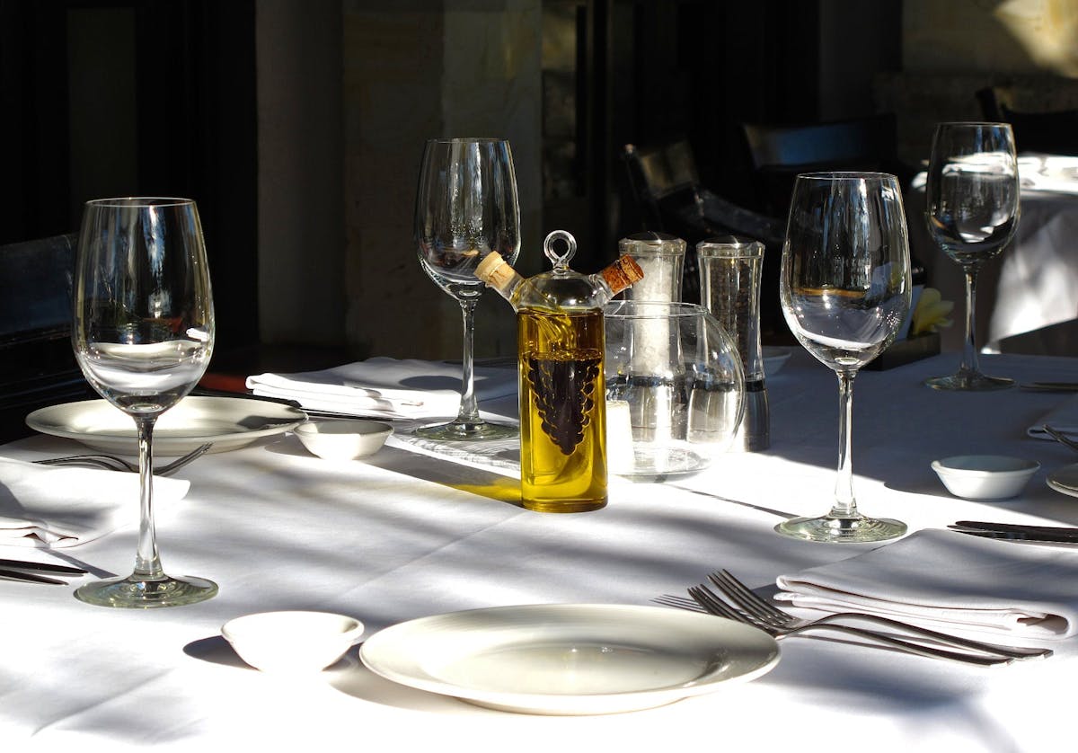 a glass of wine sitting on top of a table