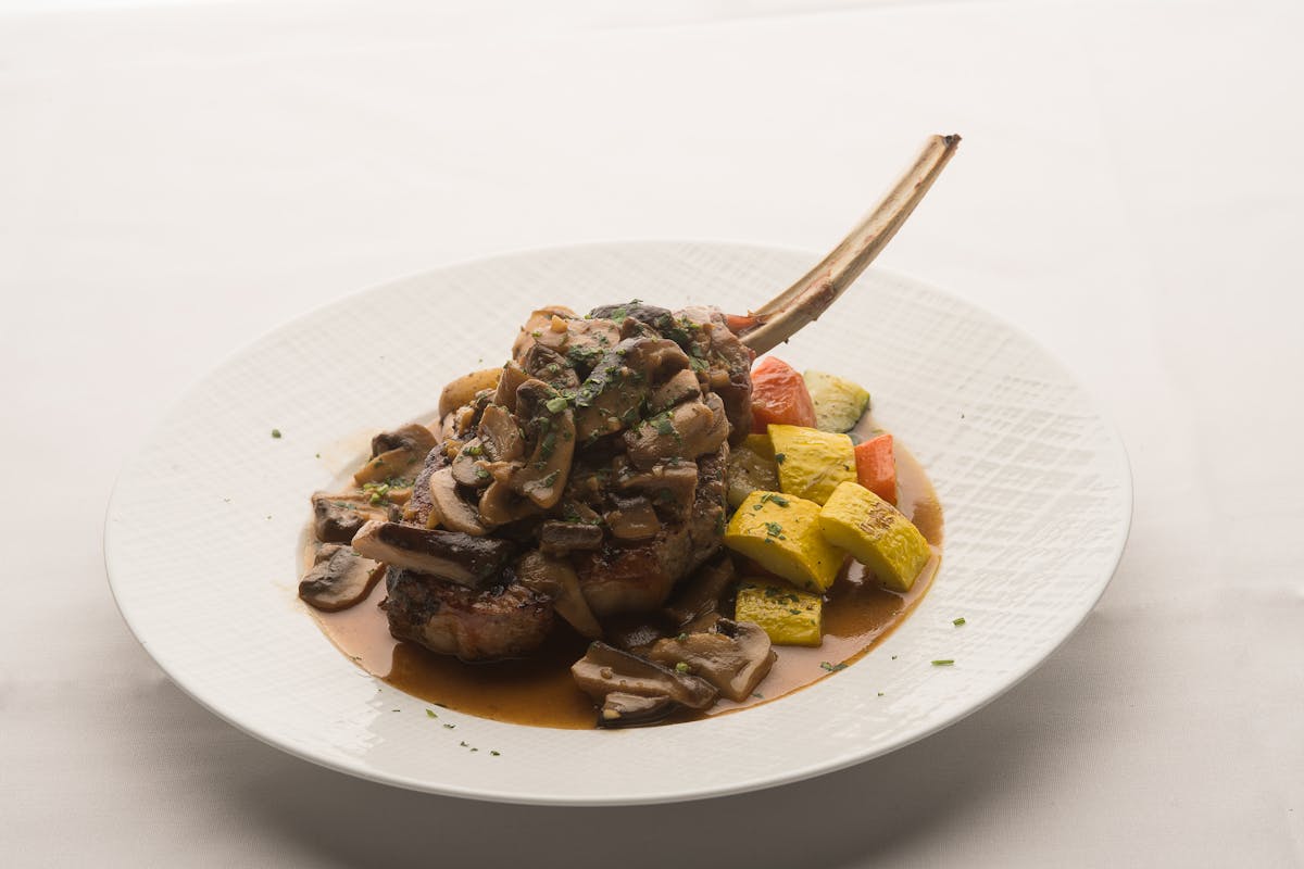 A close up of a pork chop on a plate