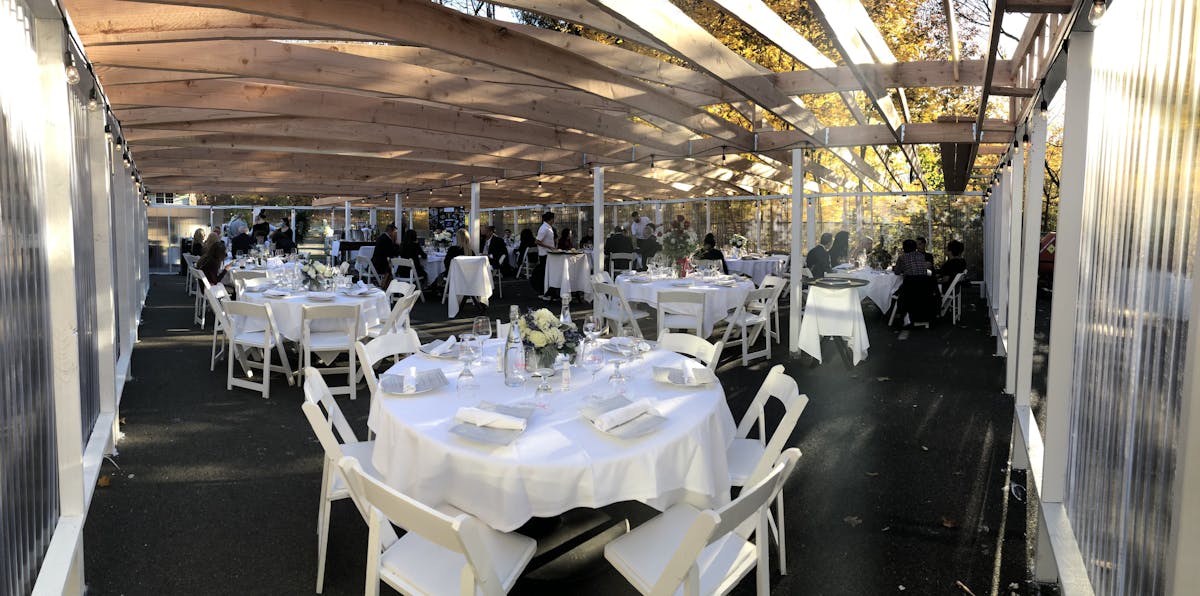 A bunch of tables set under a tent