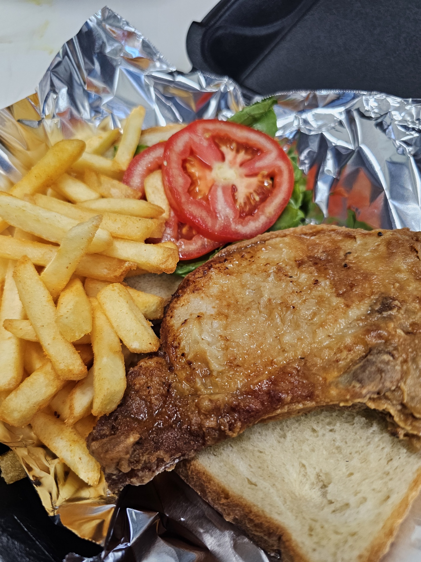 a close up of a sandwich and fries on a plate