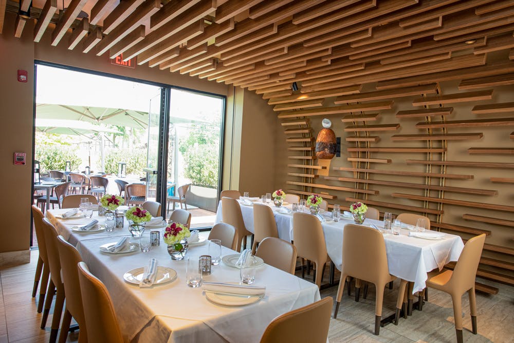 a dining room table in front of a window