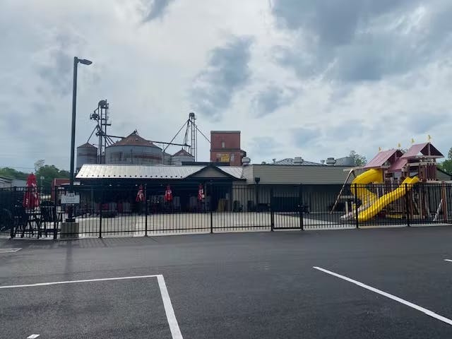 a group of people standing in a parking lot