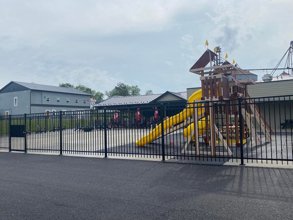a group of people standing next to a fence