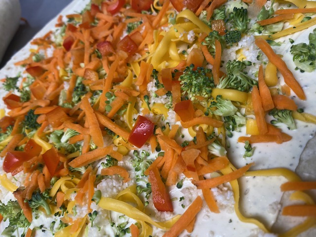 a pizza with cheese and broccoli