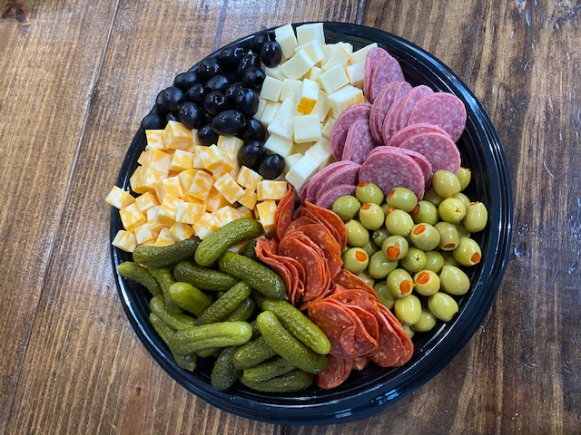 a bowl of fruit sitting on top of a wooden table