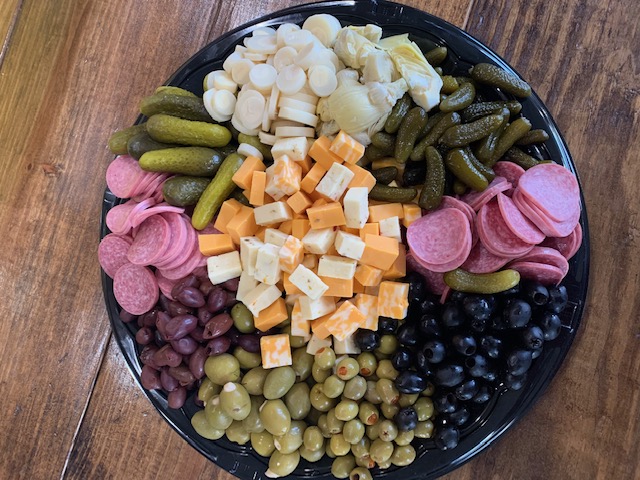 a plate full of food sitting on top of a wooden table
