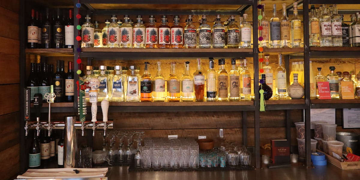 a bottle of wine and a glass display case