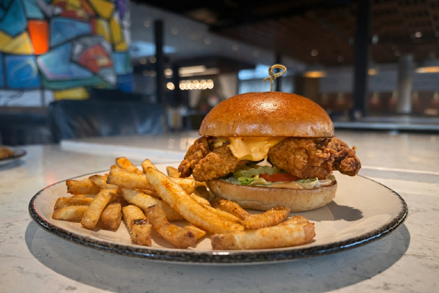 a sandwich sitting on top of a plate of food on a table
