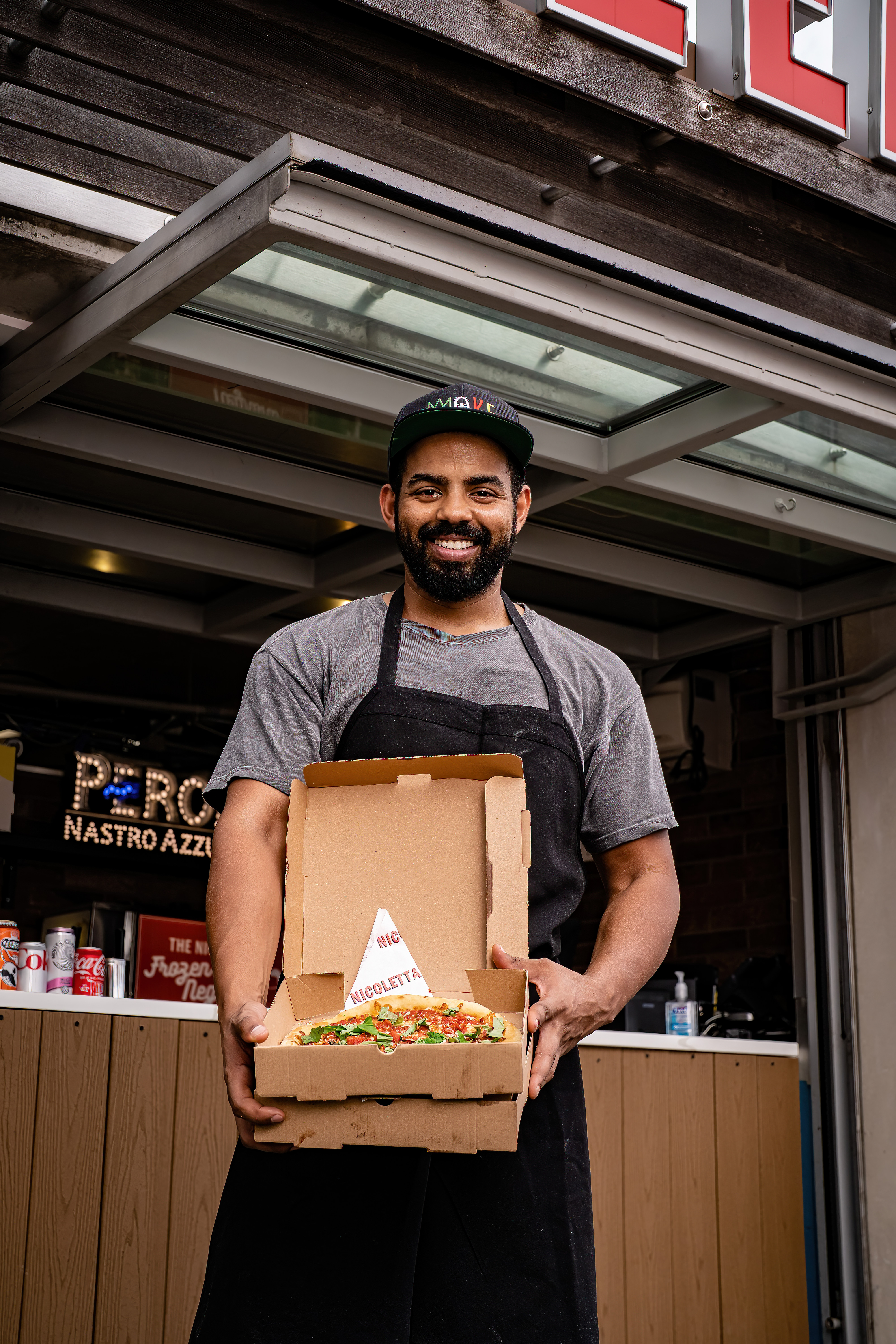 a man standing in front of a cake