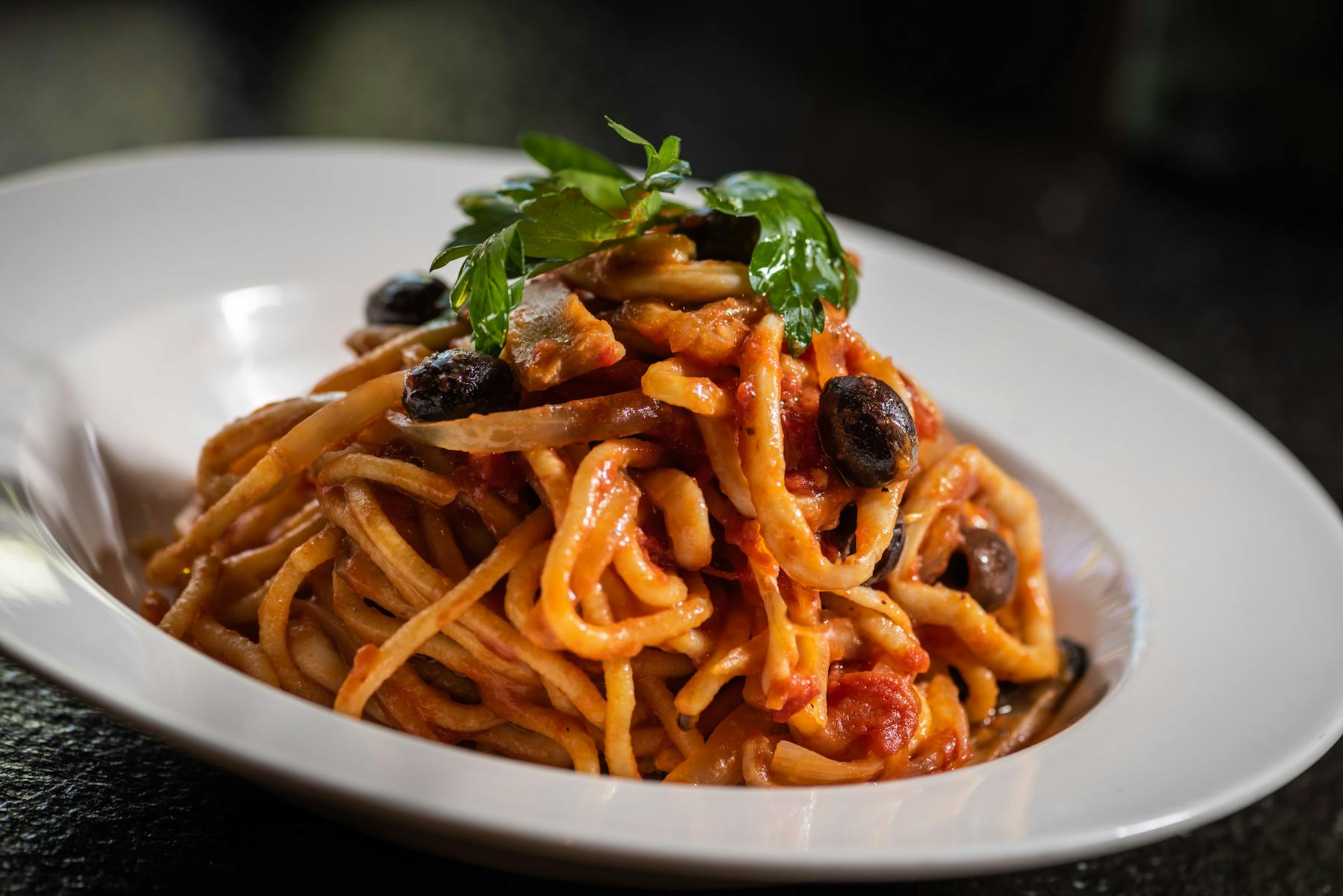 a white plate topped with pasta and vegetables