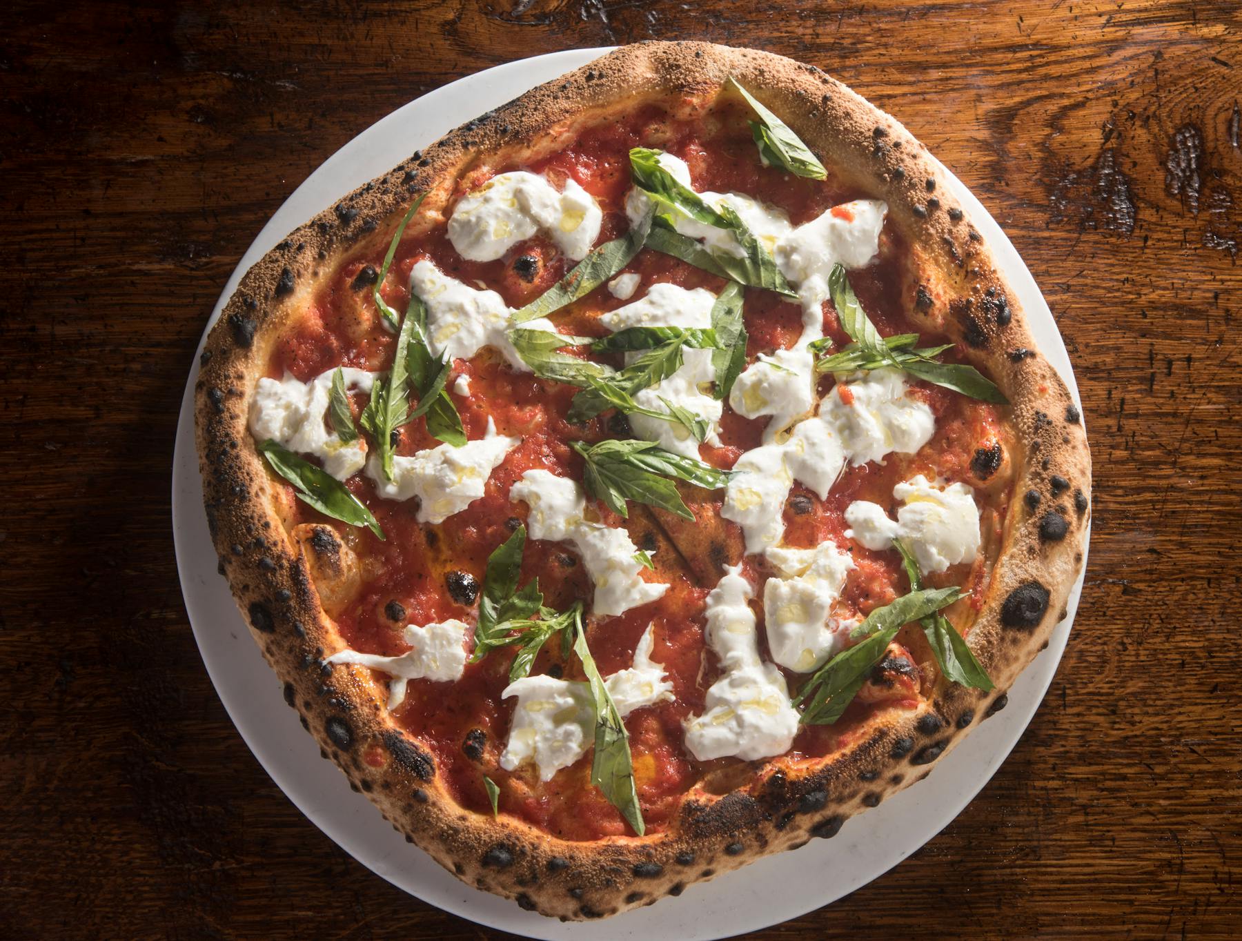a pizza sitting on top of a plate of food