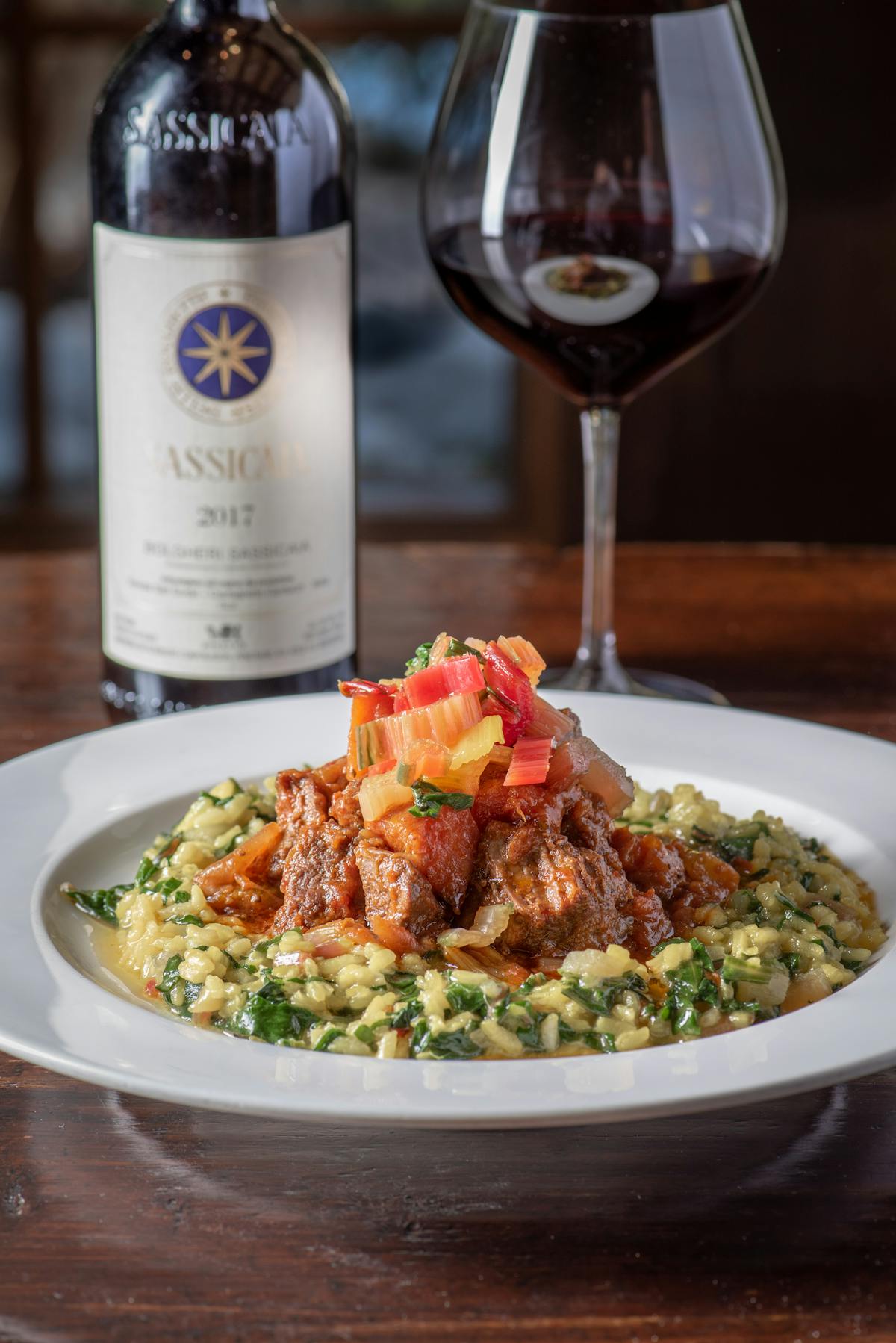 a plate of food and a glass of wine