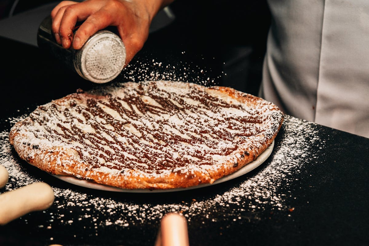 a close up of a person holding a slice of pizza