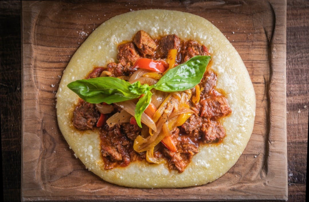 a pizza sitting on top of a wooden cutting board