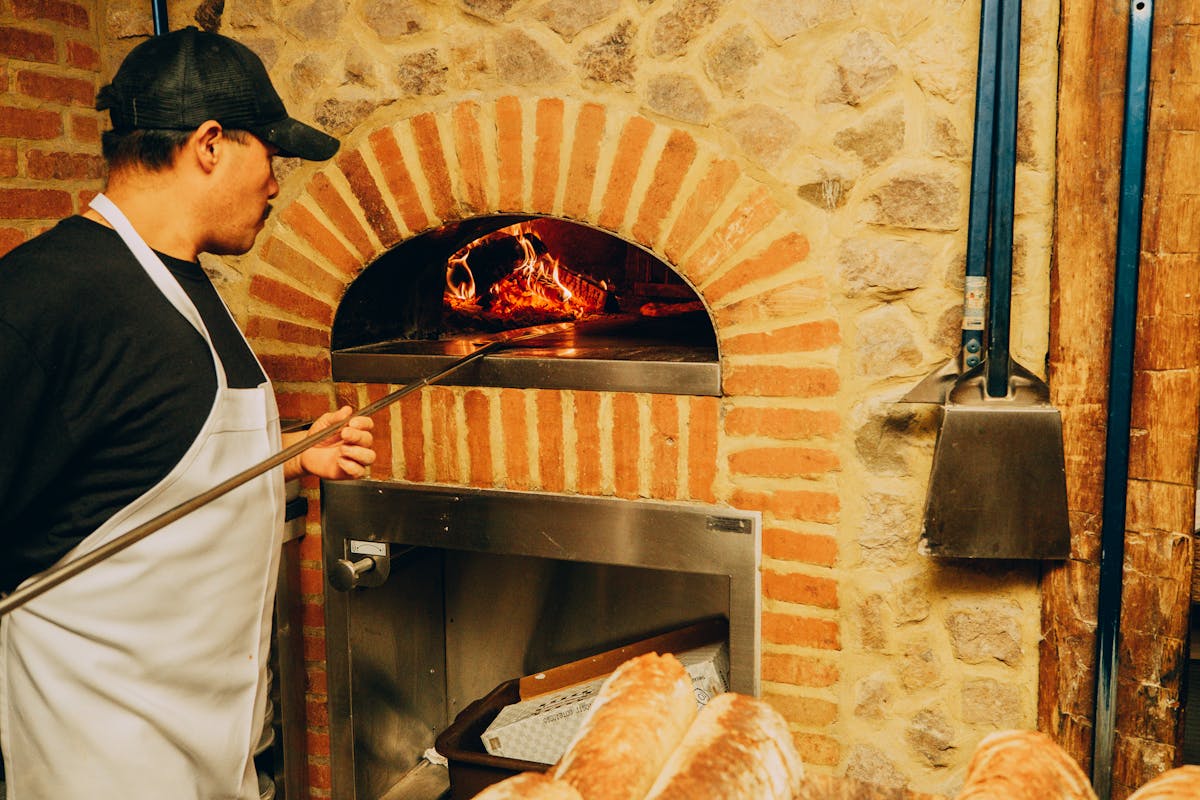 a man cooking in an oven