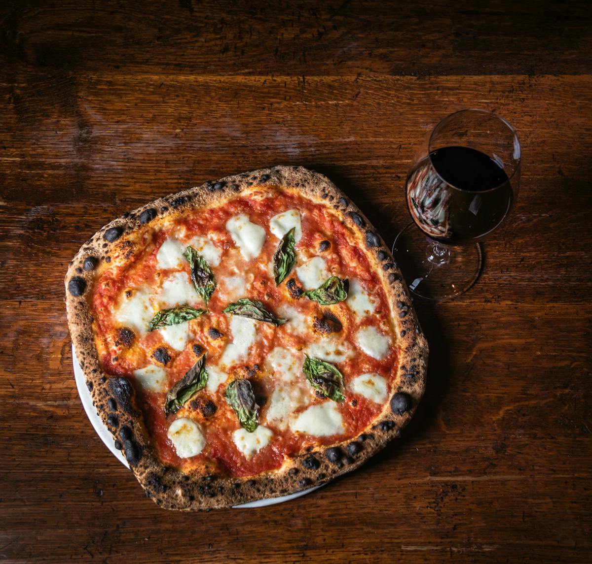 a pizza sitting on top of a wooden table