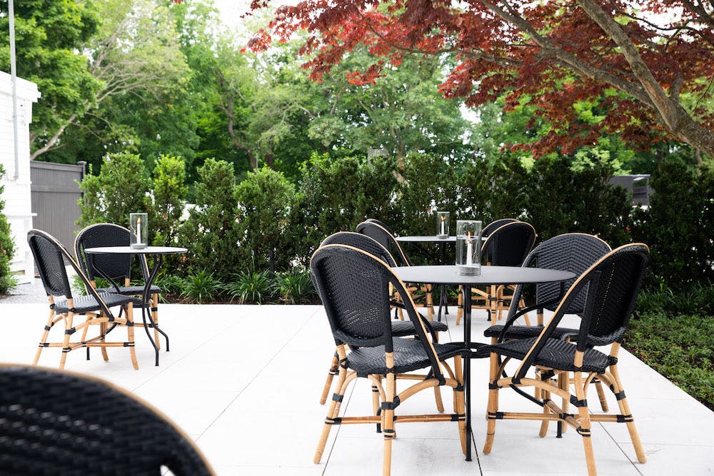 a couple of lawn chairs sitting on top of a wooden chair