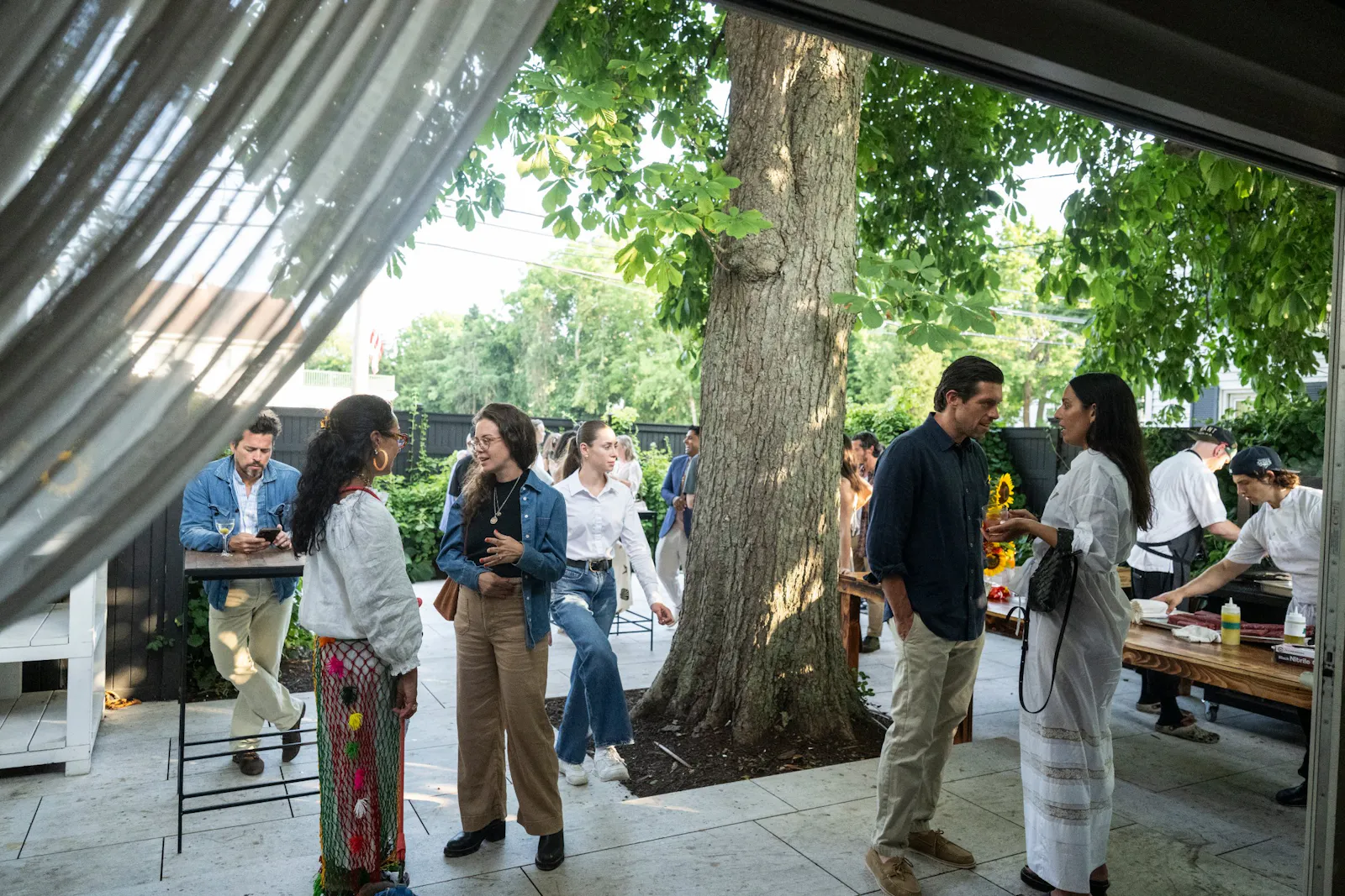Guests gathered under the walnut tree on the West Patio