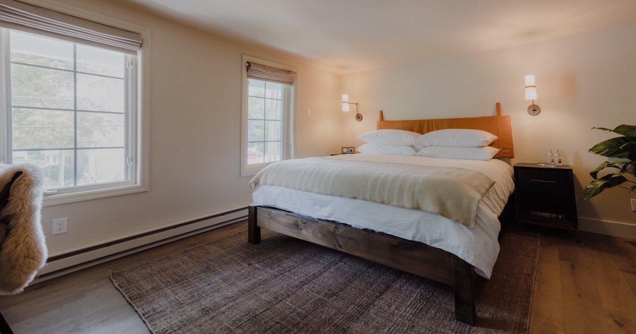 a bedroom with a bed and looking at the camera