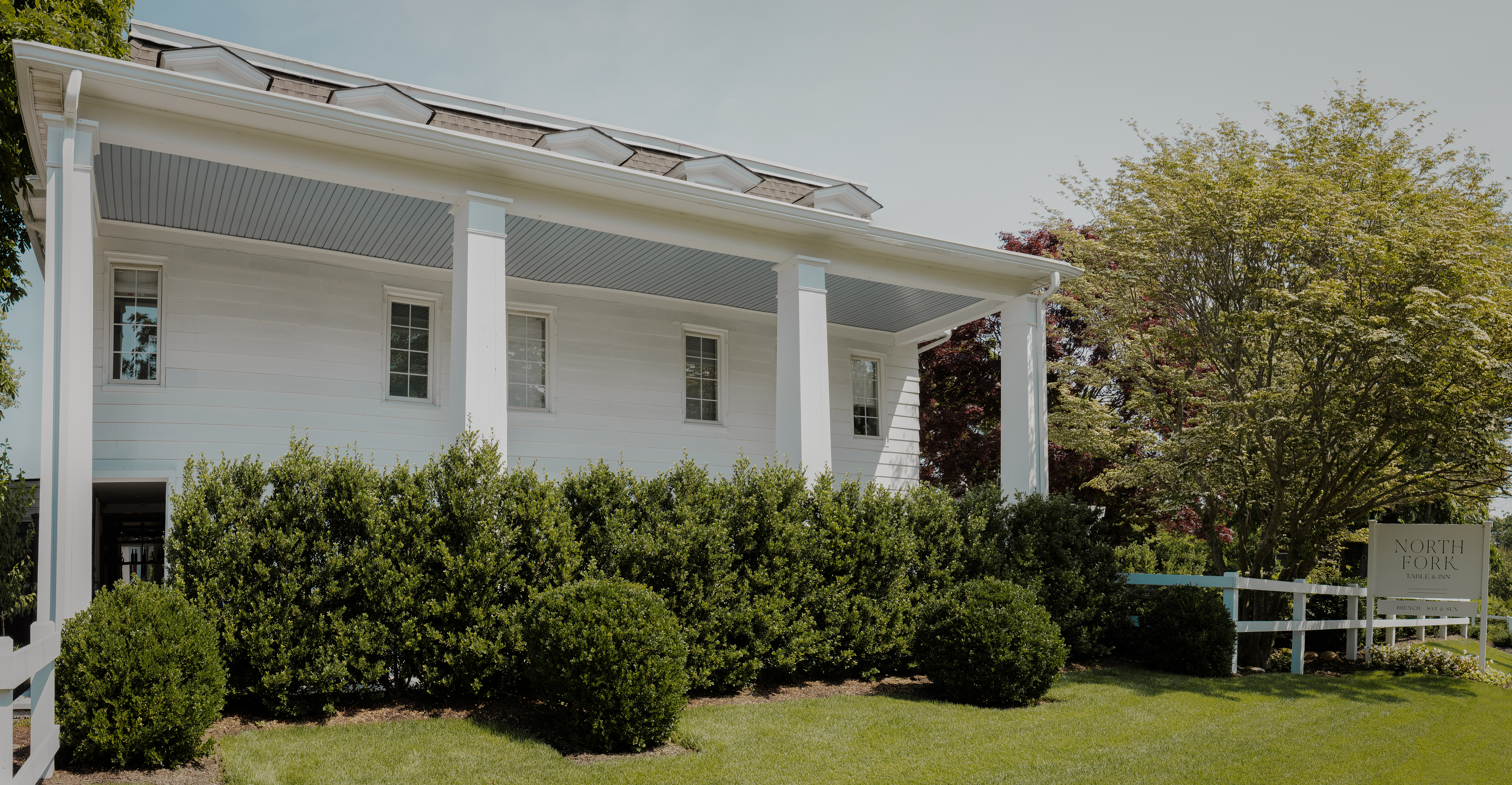 a house with bushes in front of a building