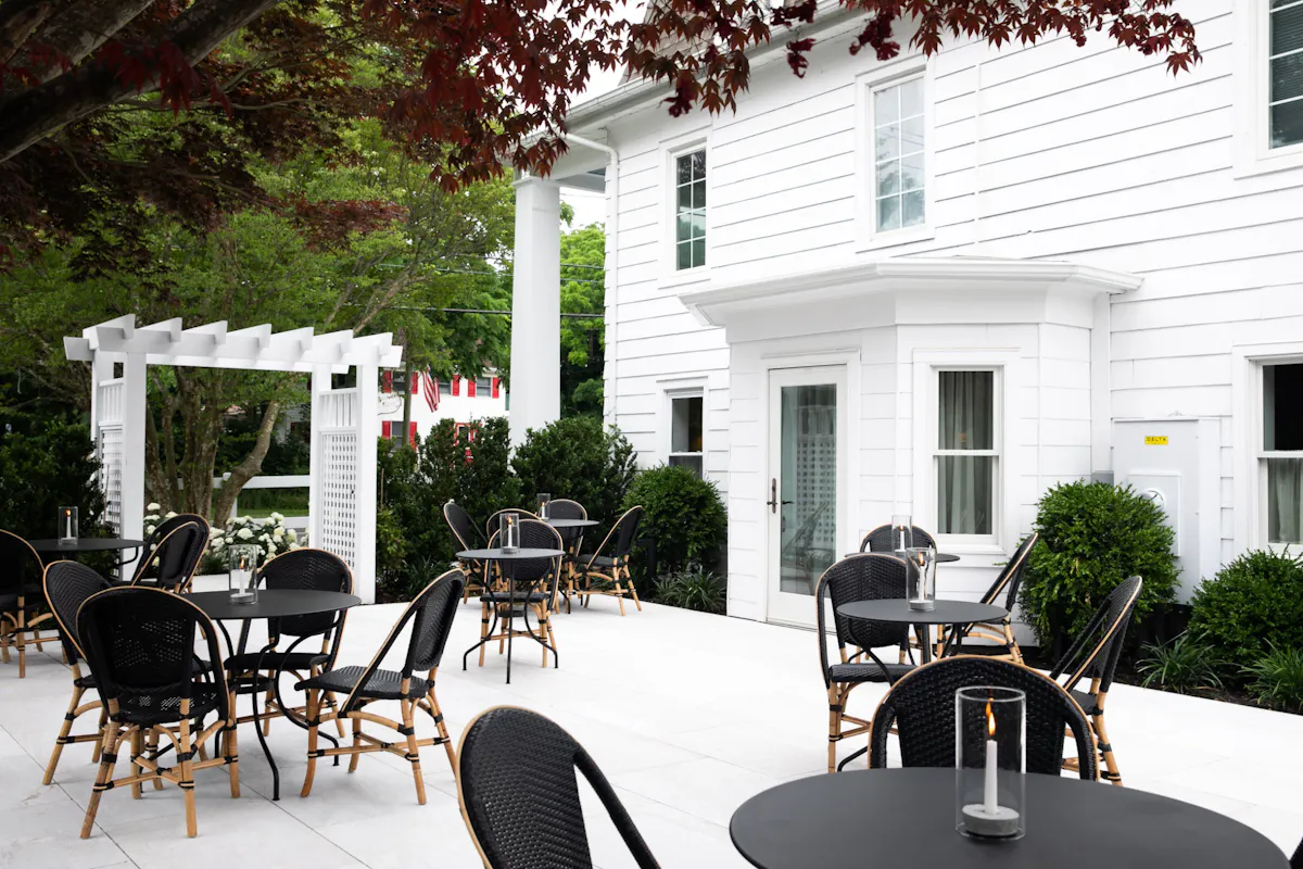 East Patio tables beside the white inn