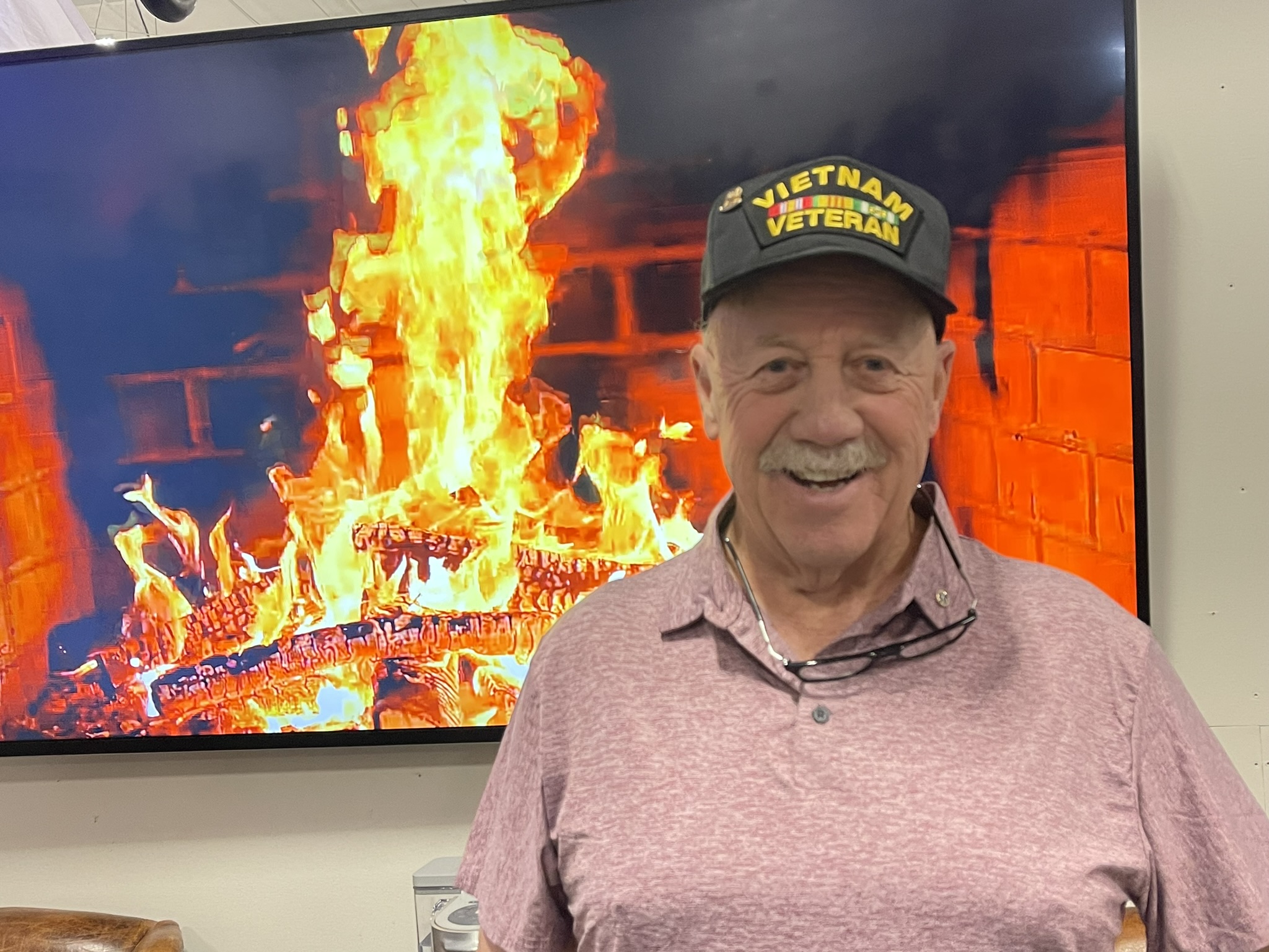 a man standing in front of a fire
