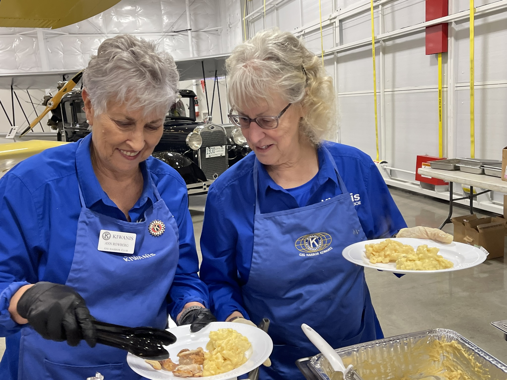 a group of people sitting at a table with a plate of food